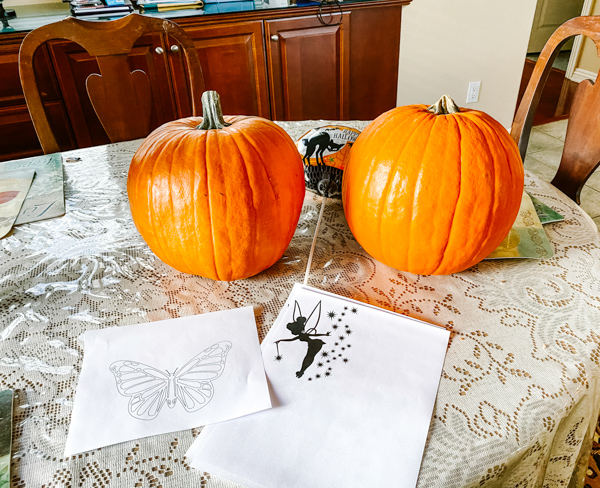 Two Pumpkins with designs printed to be carved